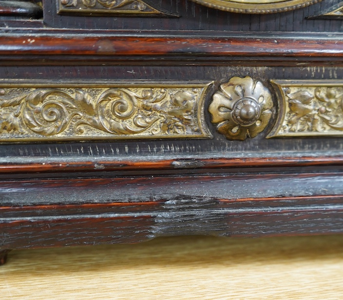 A late Victorian oak eight day mantel clock, striking on a coiled gong, height 26.5cm. Condition - fair, wear and oxidisation to dial.